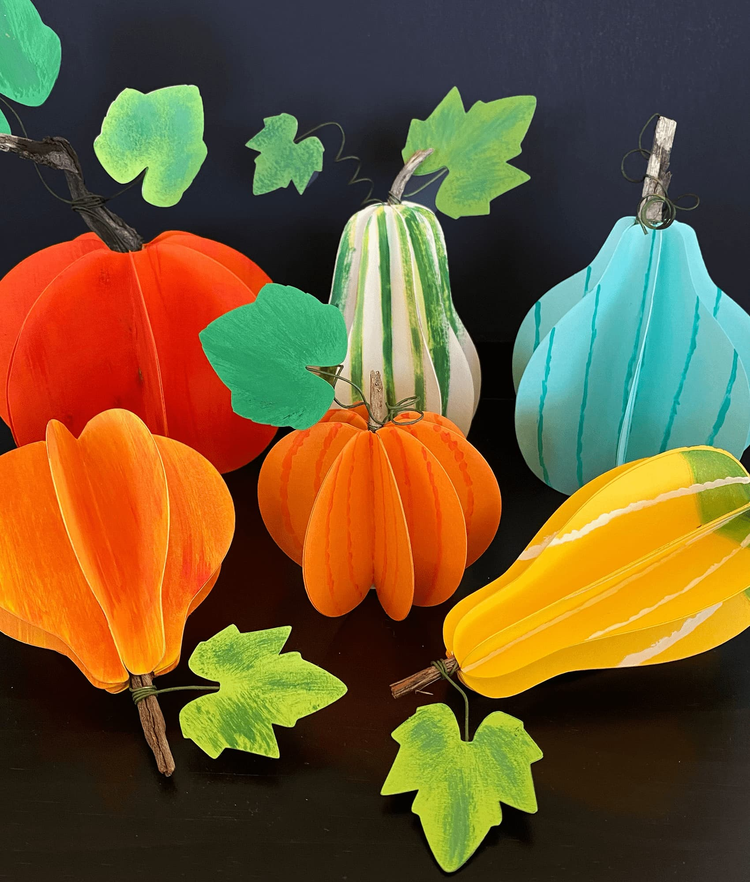 a collection of colorful handmade paper pumpkins and squashes