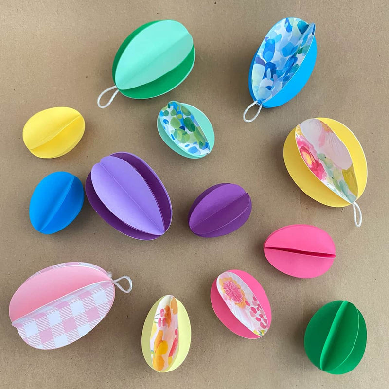 Colorful paper Easter eggs on a brown background