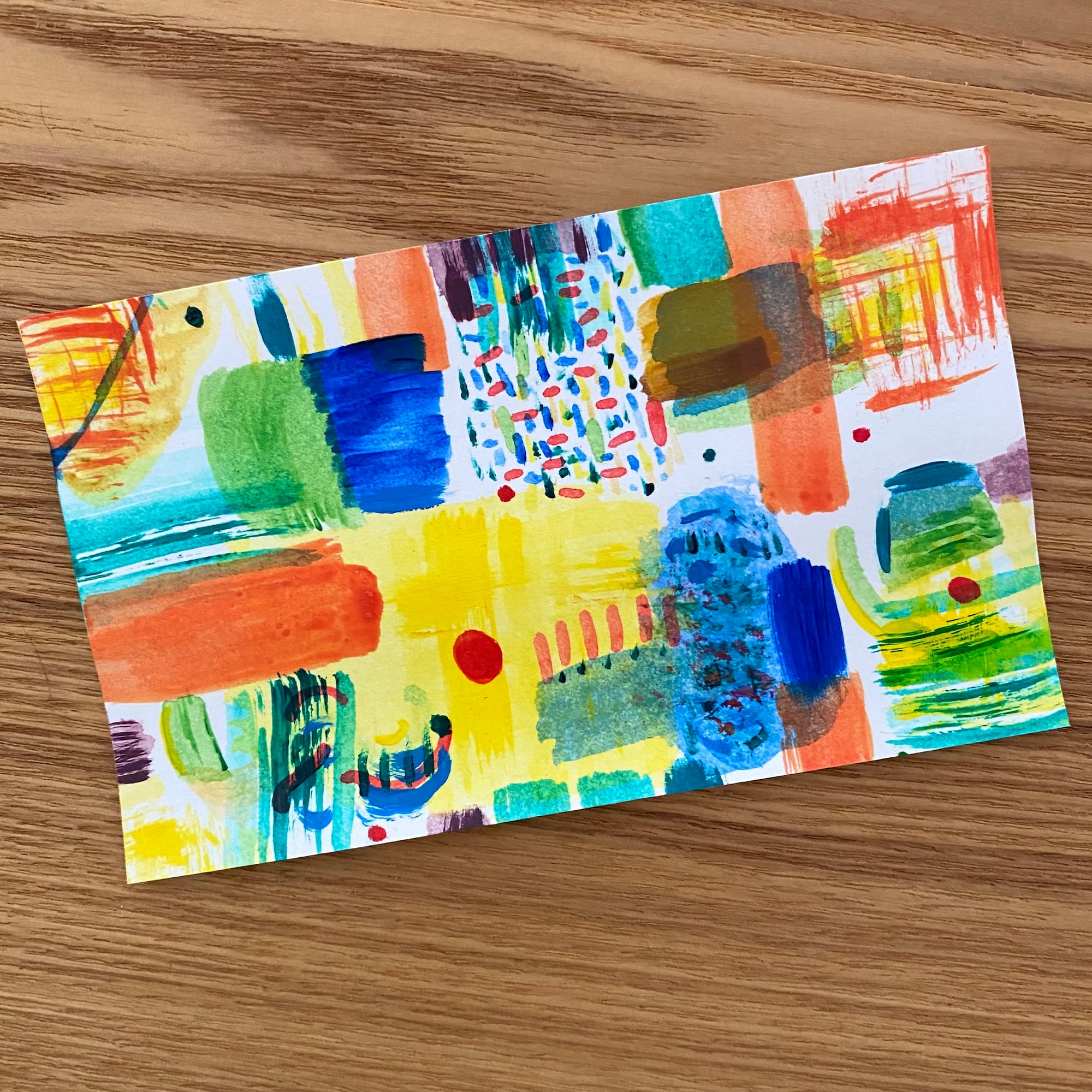 abstract painting in various shapes and color overlays in vivid blue, green, yellow, orange and red, done in acrylic paints
