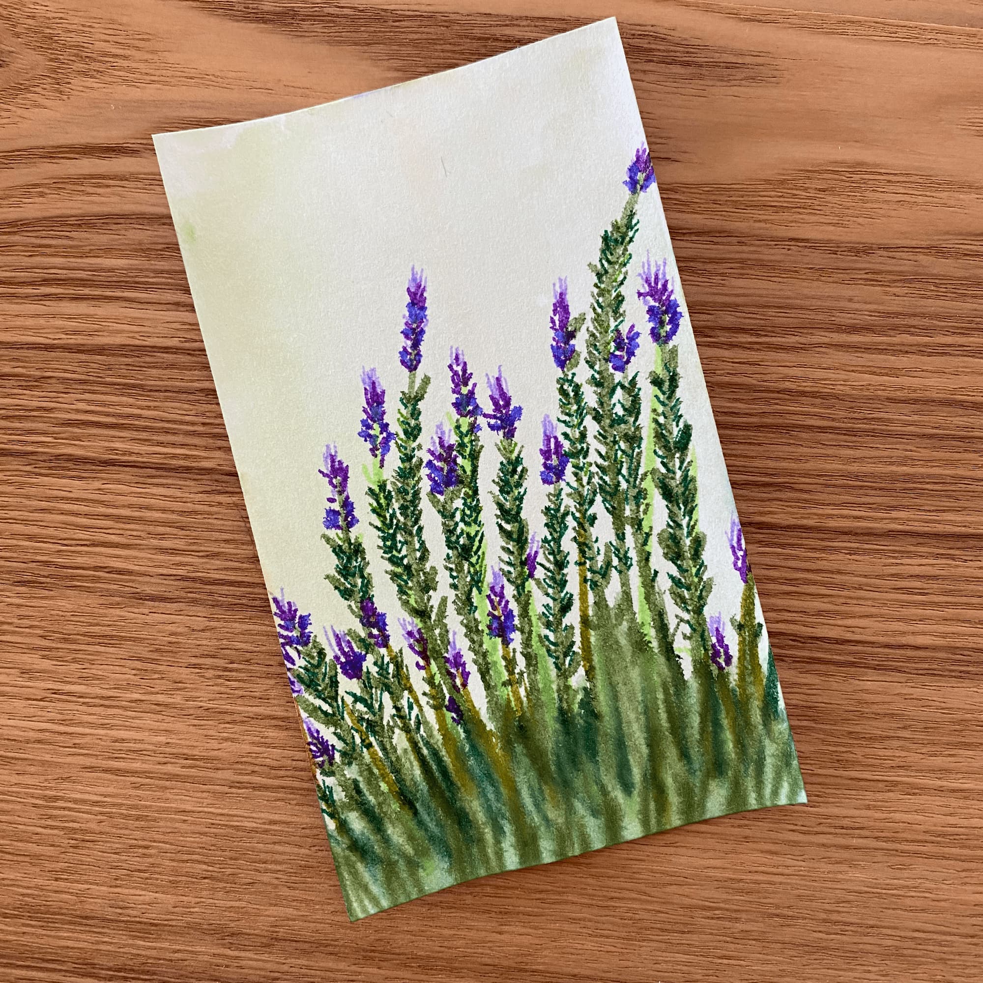 painting on an index card of lavender plants against a pale green background.
