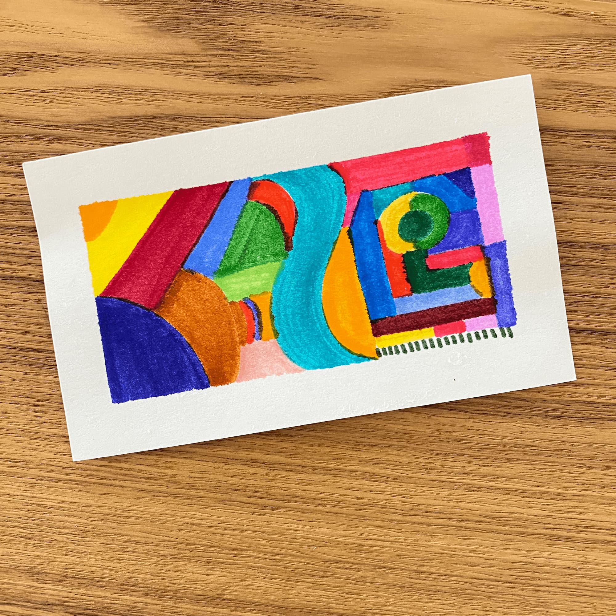 abstract drawing on an index card with multicolor shapes fitted together