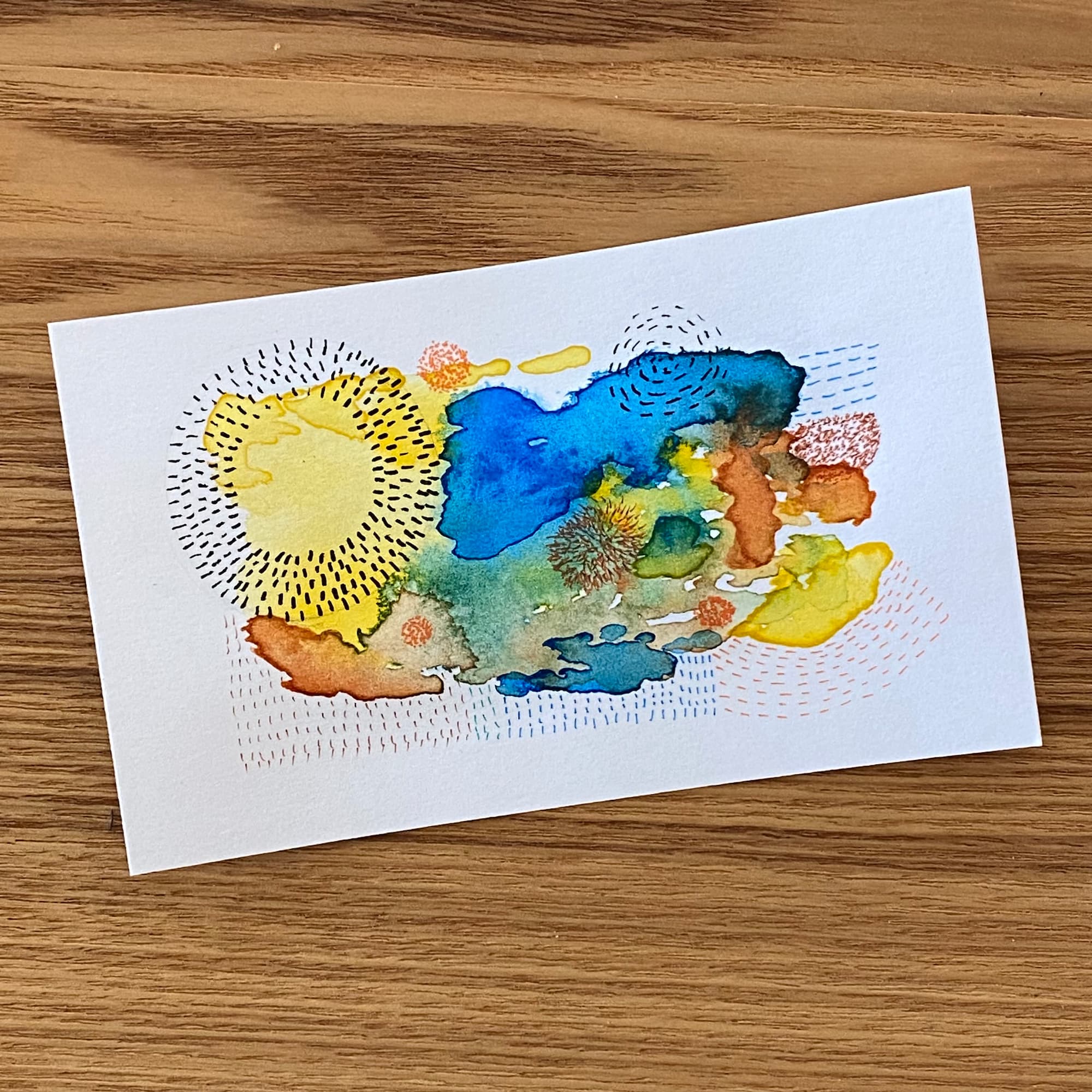 abstract watercolor paiinting with ink markings, done in yellow, bronze and blue