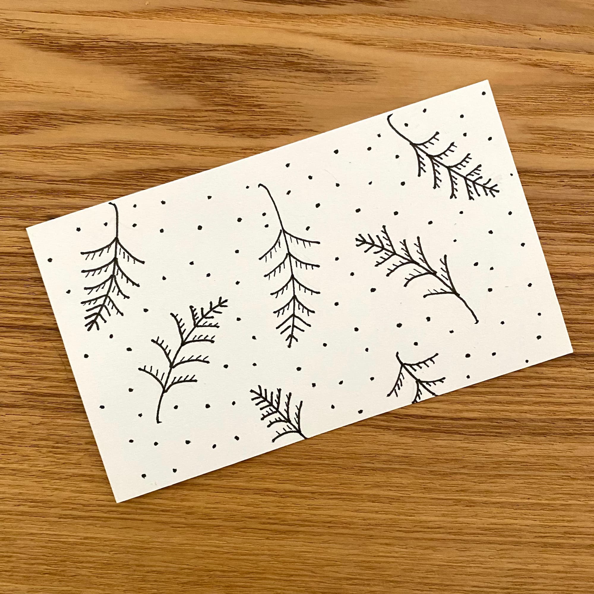 pen and ink sketch of a simplified fern pattern with small dots in the background