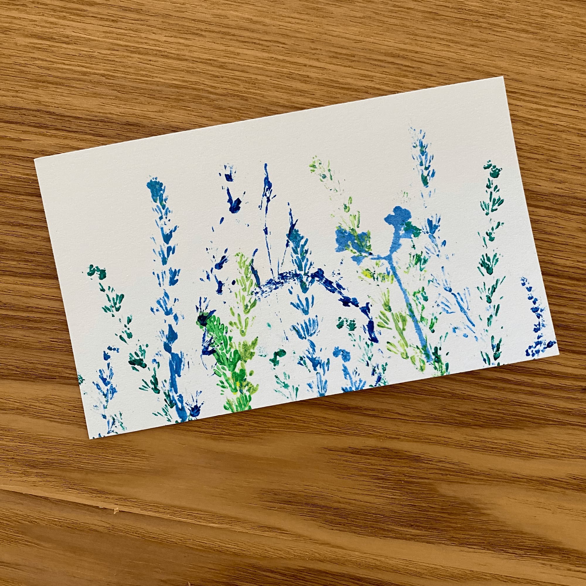 abstract floralscape of plant stalks done in shades of blue and green.