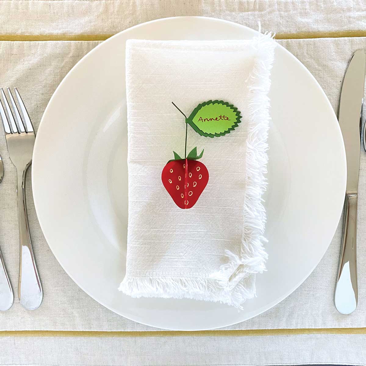 Handmade Paper Strawberries showm as part of a place setting