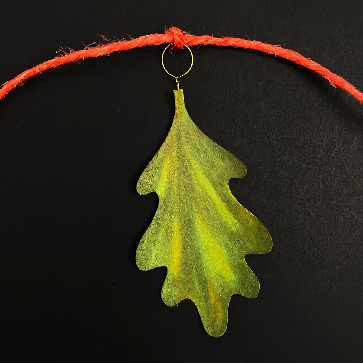 Tying leaf and pin sets to twine for DIY acorn and leaf garland, part of Cakewalk DIY Paper Craft tutorial