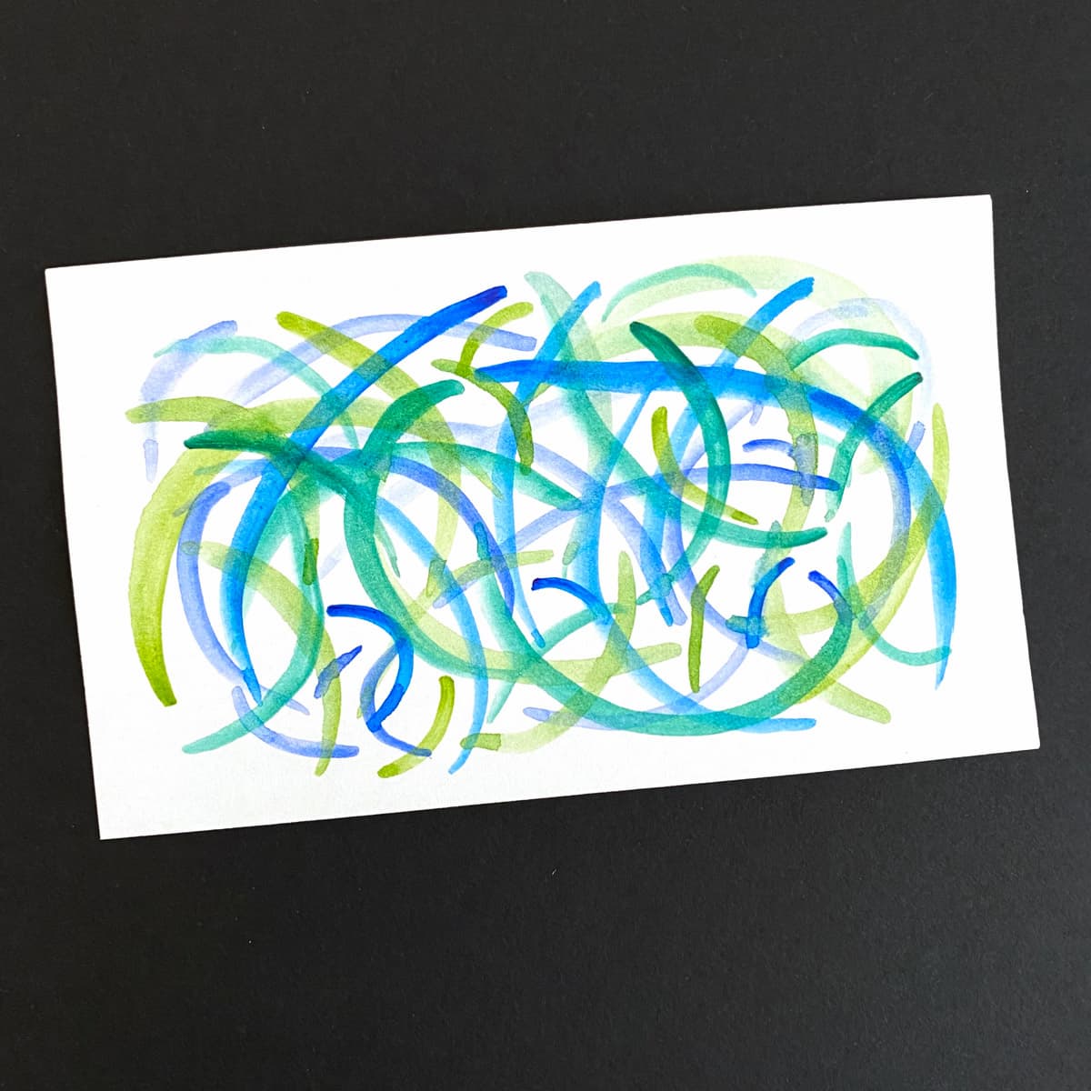 Index card with a abstract painting of watercolor strokes in various shades of blue and green on a black background by Mozaic Studio for ICAD 2025