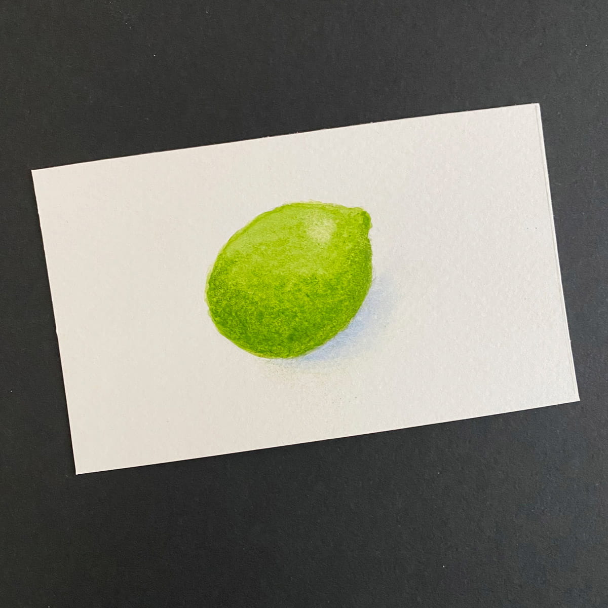 Index card with a lime painted in watercolors on a black background by Mozaic Studio for ICAD 2025