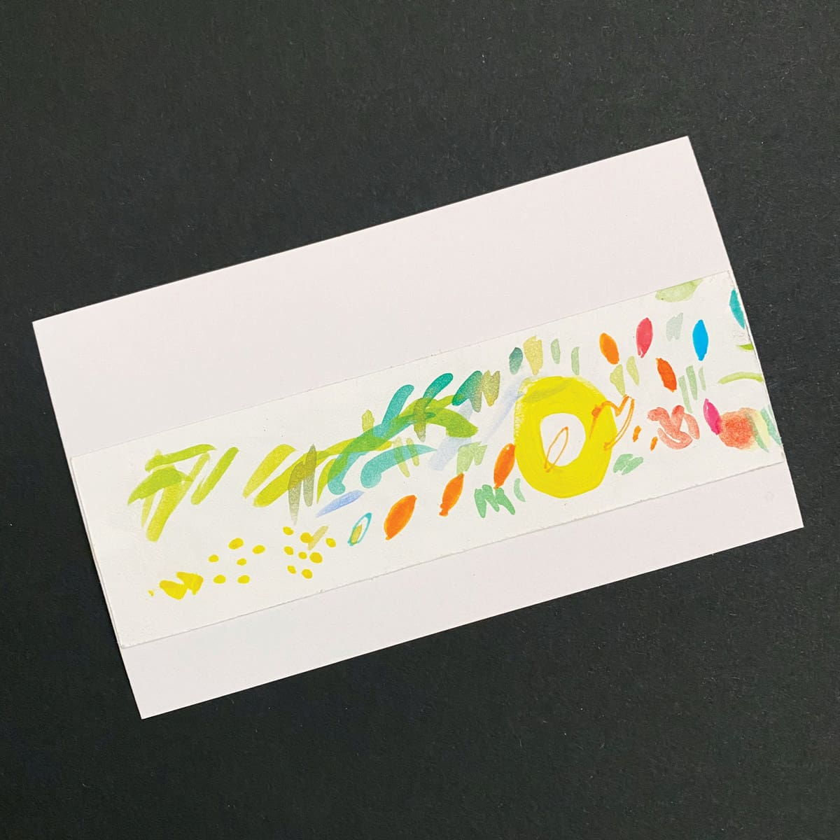 Index card with an abstract watercolor painting of multicolor marks on a black background by Mozaic Studio for ICAD 2025