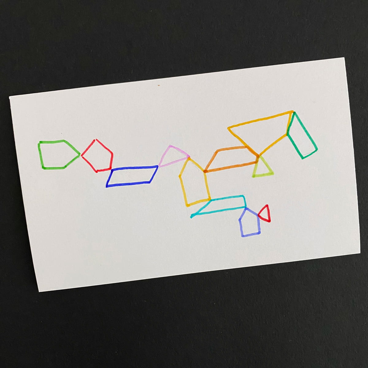 Index card with an abstract illustration of multicolor trapezoids on a black background by Mozaic Studio for ICAD 2025
