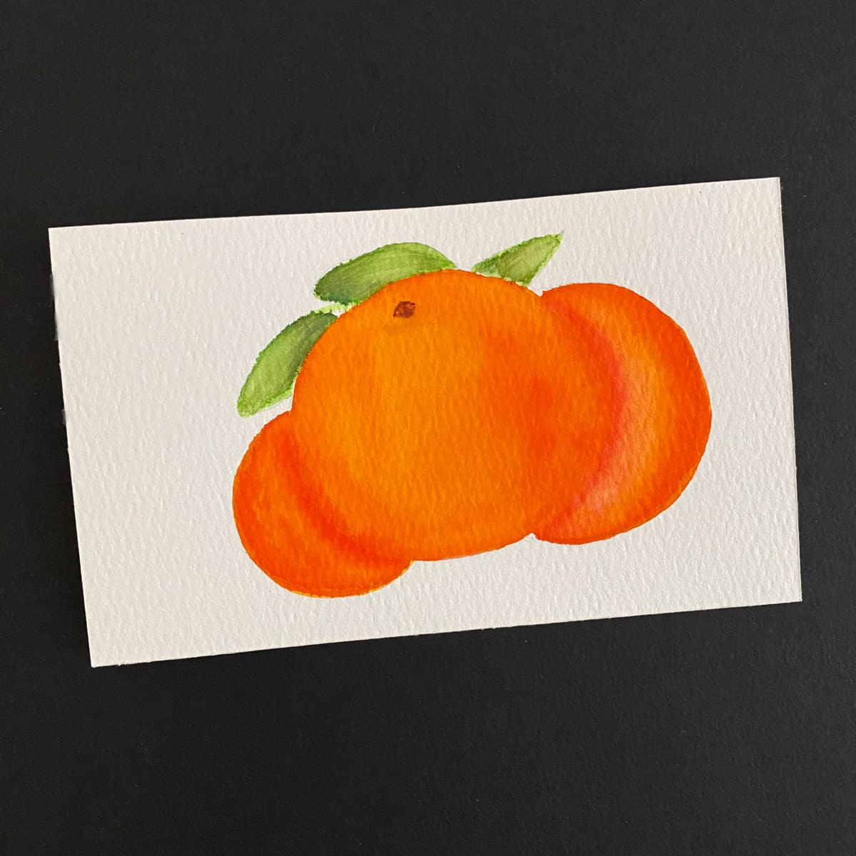 Index card with a watercolor painting of overlapping oranges on a black background by Mozaic Studio for ICAD 2025
