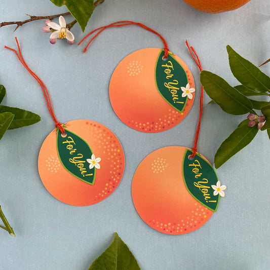 Orange Blossom gift tags with orange twine and citrus props by Mozaic Studio.