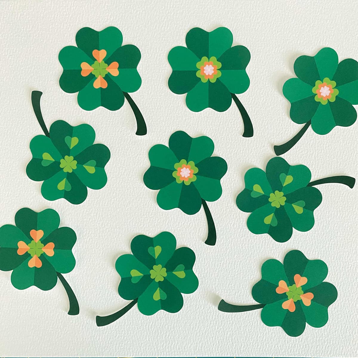Green four-leaf clovers on a white background