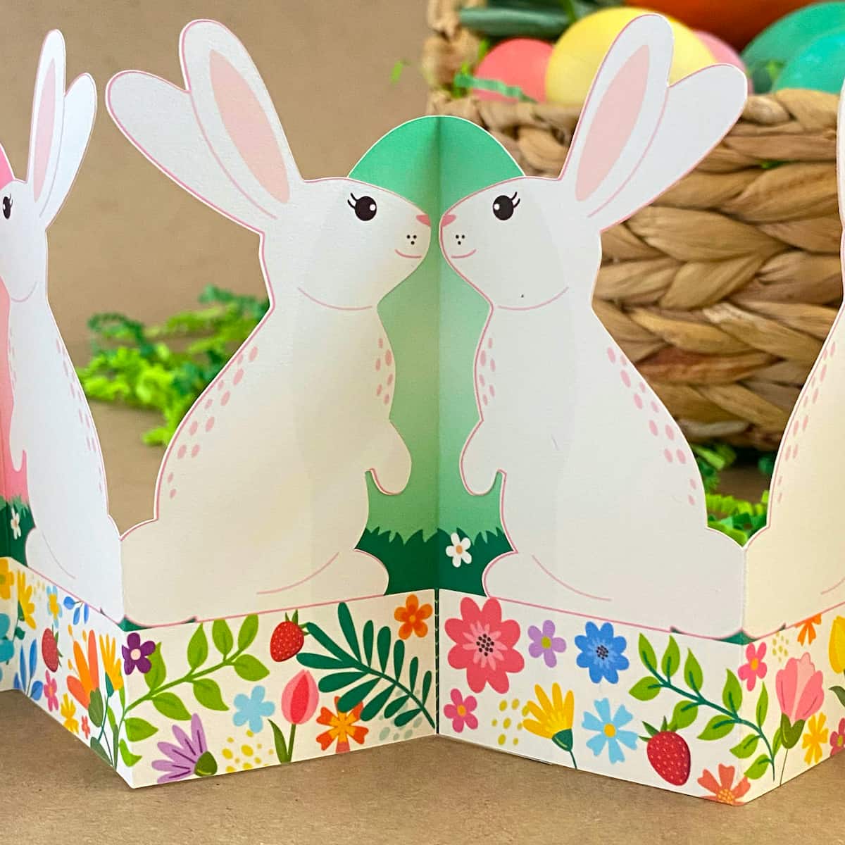 Close-up of printable standing bunny garland showing bunnies against green egg hinge – self-standing Easter garland connection detail