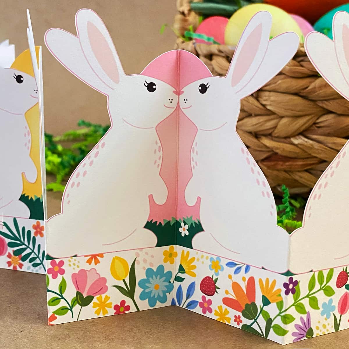 Close-up of printable standing bunny garland showing bunnies against pink egg hinge – accordion fold Easter tabletop decor detail