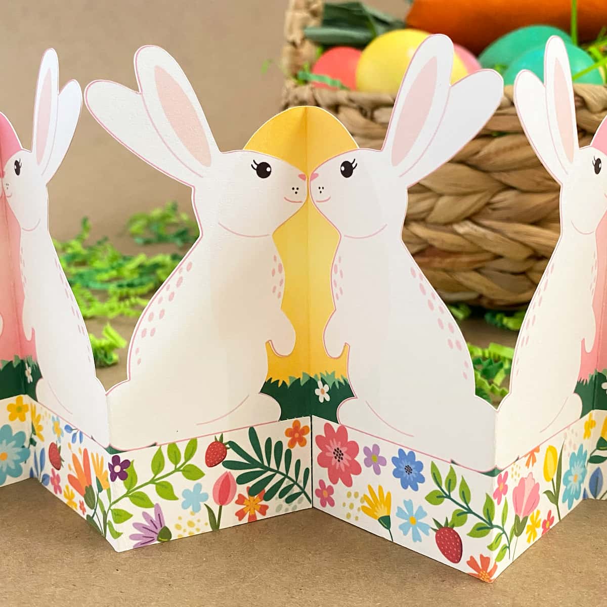 Close-up of printable standing bunny garland showing bunnies against yellow egg hinge – modular Easter paper craft detail